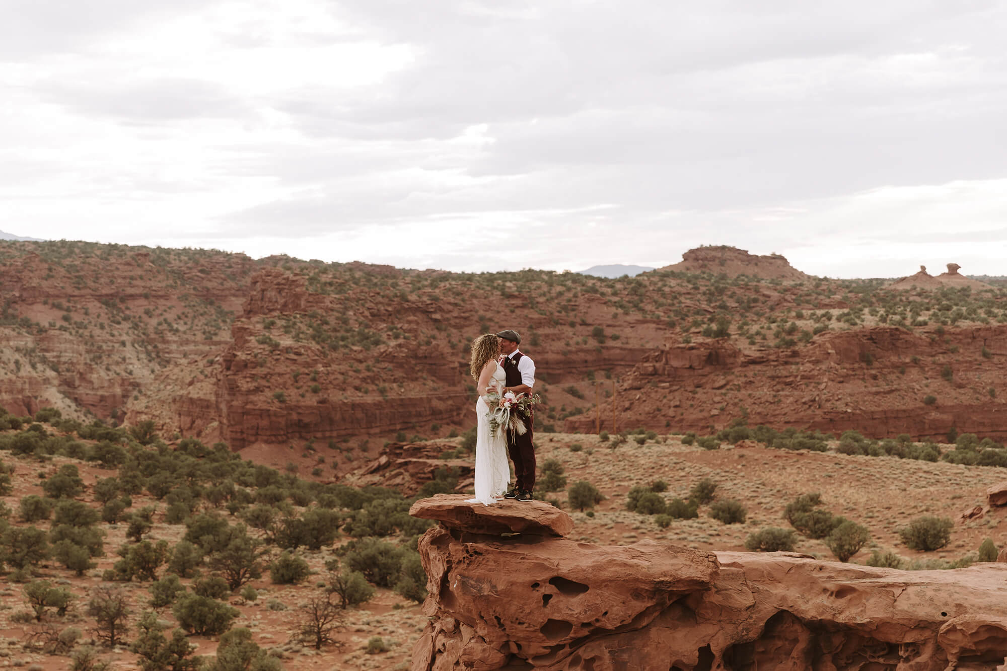 A bride and groom pose for an epic portrait in Capitol Reef National Park following their elopement ceremony.